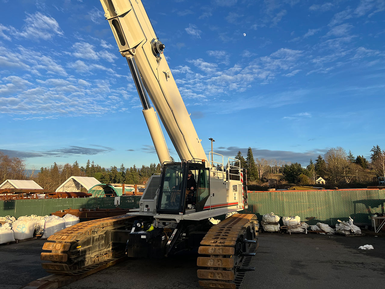 Image of a crane in front of a fence | Crane Safe LLC