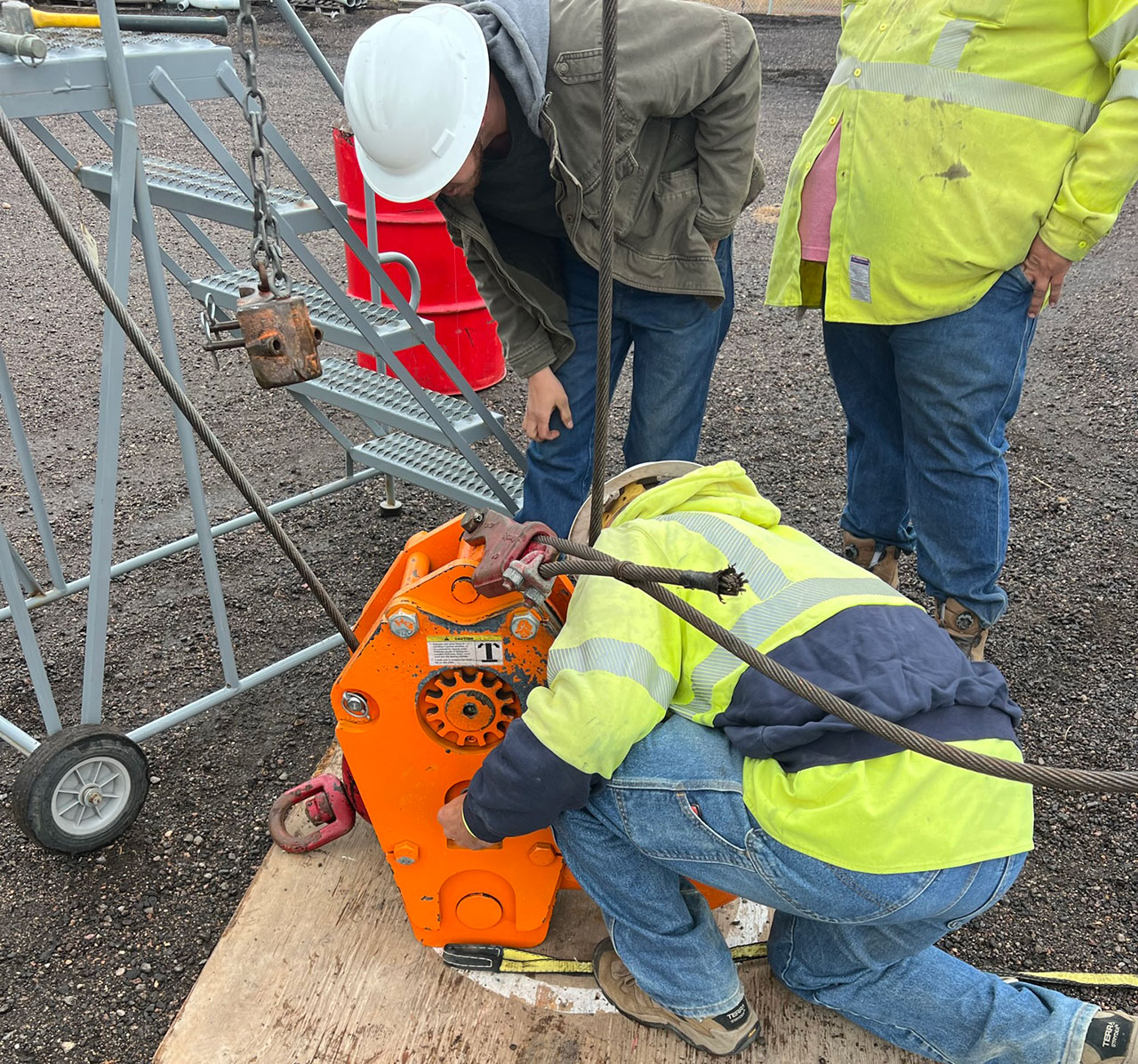 Image of 3 men looking over a crane mount and learning | Crane Safe LLC